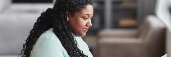 woman looking at computer developing skills