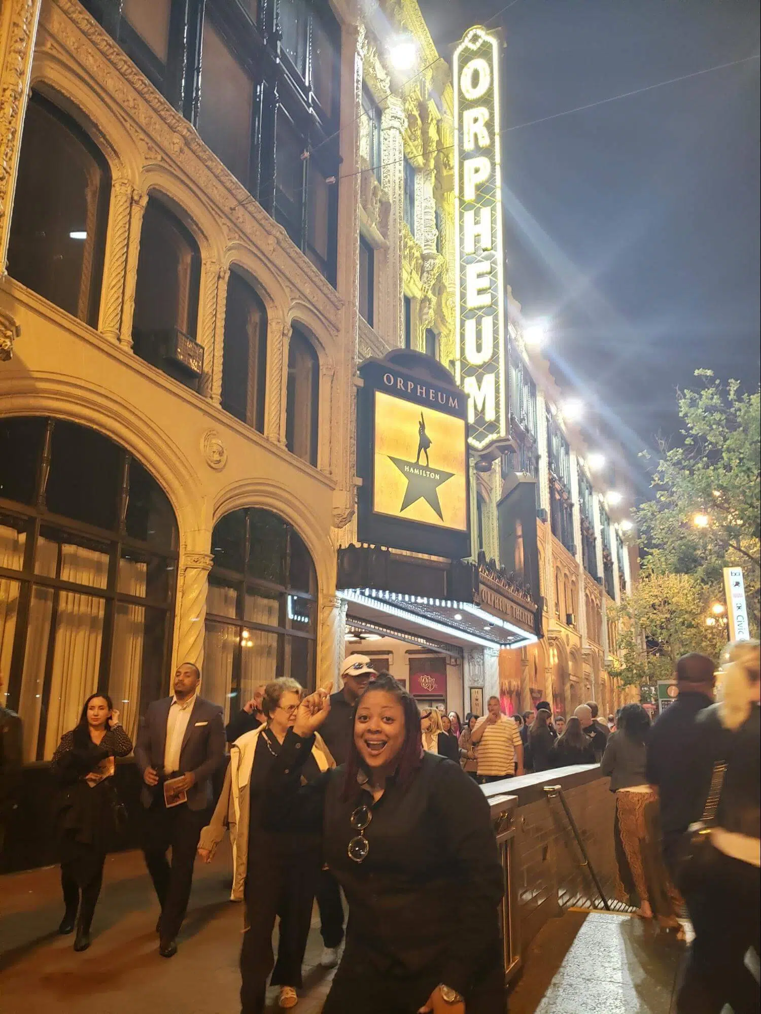 Dominique Hollins in front of a production of "Hamilton"