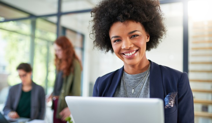 cheerful woman working on a laptop at office 2026 01 09 11 00 42 utc 1