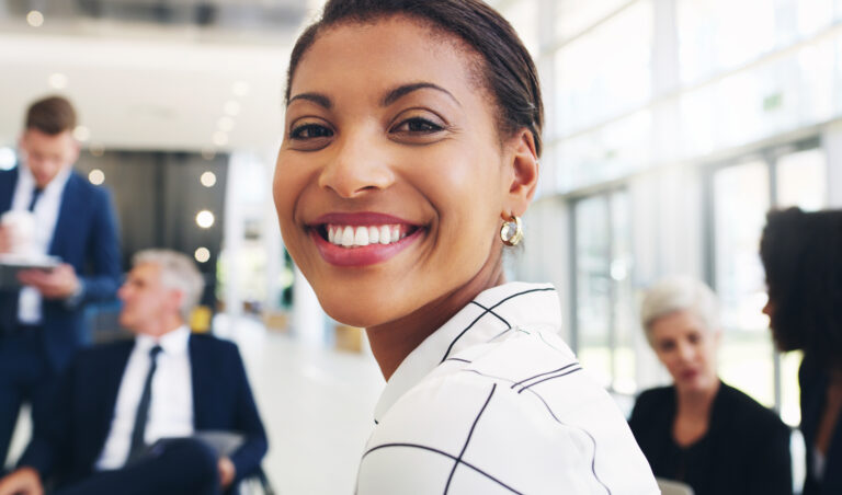 smiling woman at office with coworkers around 2026 03 25 01 27 57 utc 1