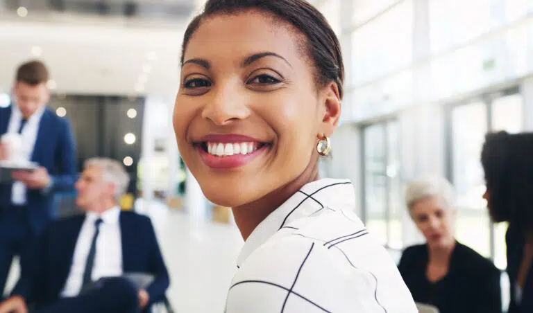 smiling woman at office with coworkers around 2026 03 25 01 27 57 utc 1