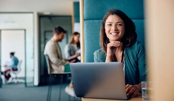 smiling woman working on a laptop at workplace 2026 01 06 10 28 59 utc 1 1